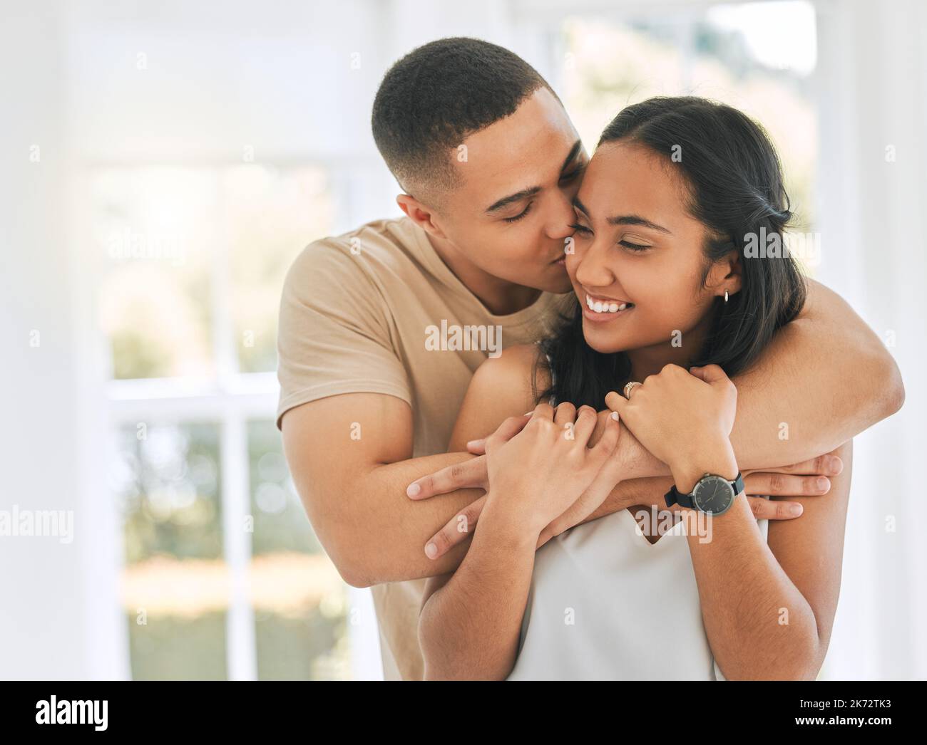 Showering her with affection. an affectionate young couple at home