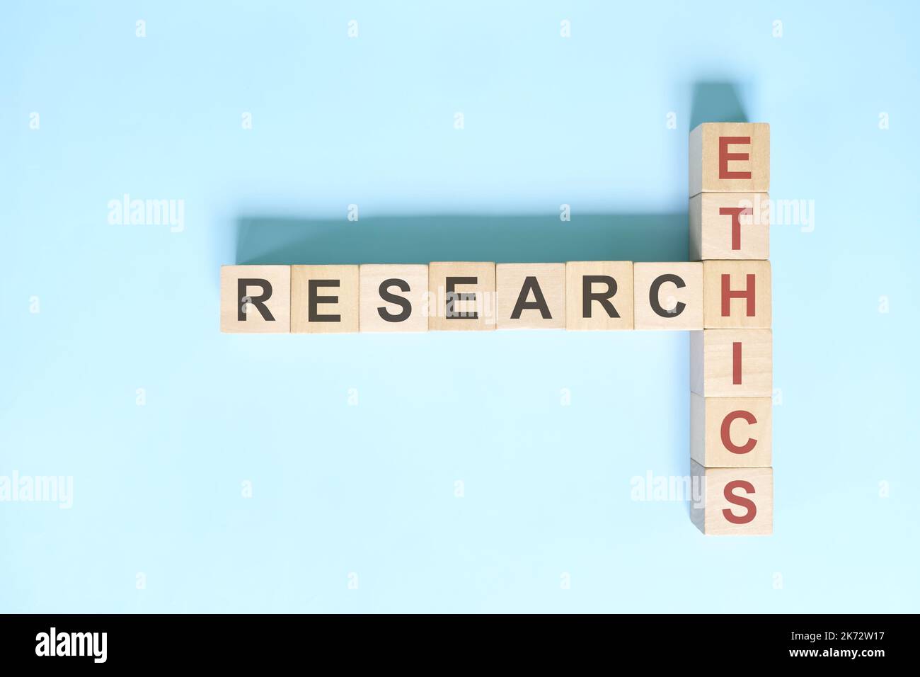 Research ethics concept Crossword puzzle flat lay typography in blue Research ethics concept Crossword puzzle flat lay typography in blue