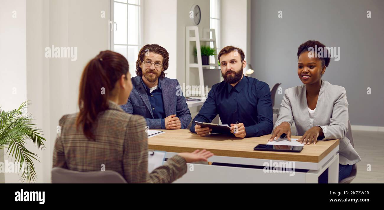 Multiracial team of three HR managers interviewing a job candidate in the office Stock Photo