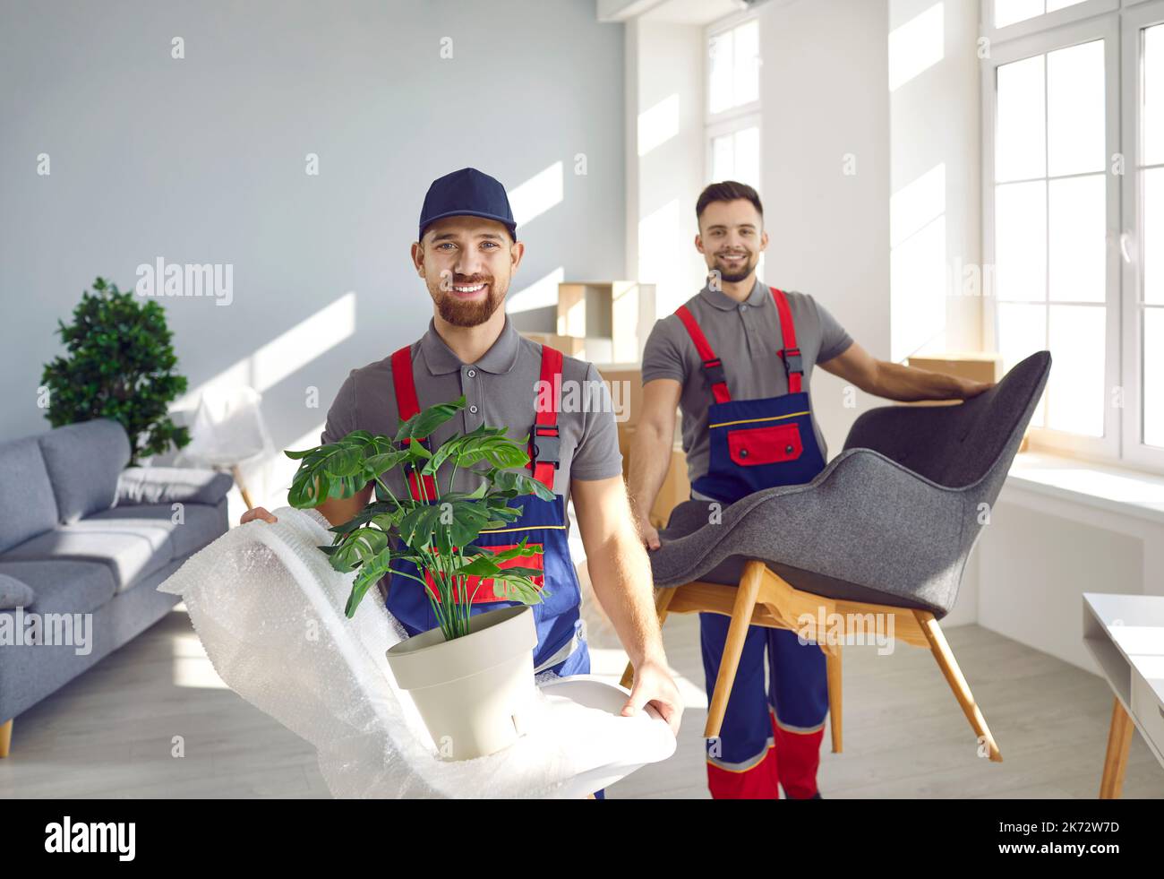 Two workers from moving company removing furniture and other things from apartment Stock Photo