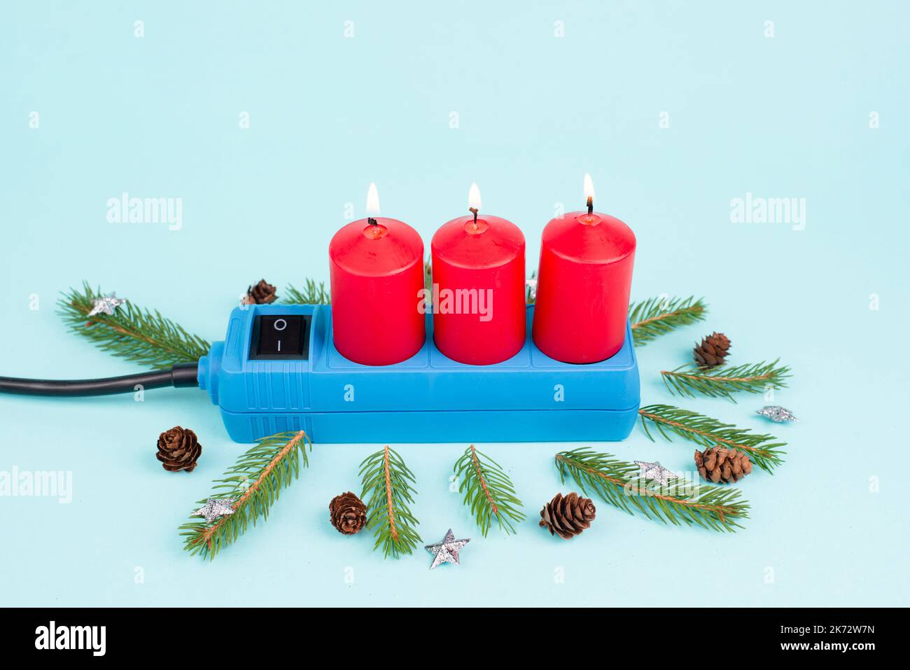 Red christmas candles in a socket, expensive electricity costs, blackout risk in Germany, cold winter with rationing Stock Photo
