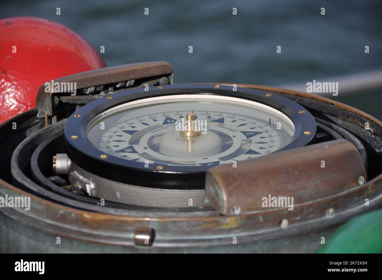 Compass of an old sailing ship shows the way in detail view Stock Photo