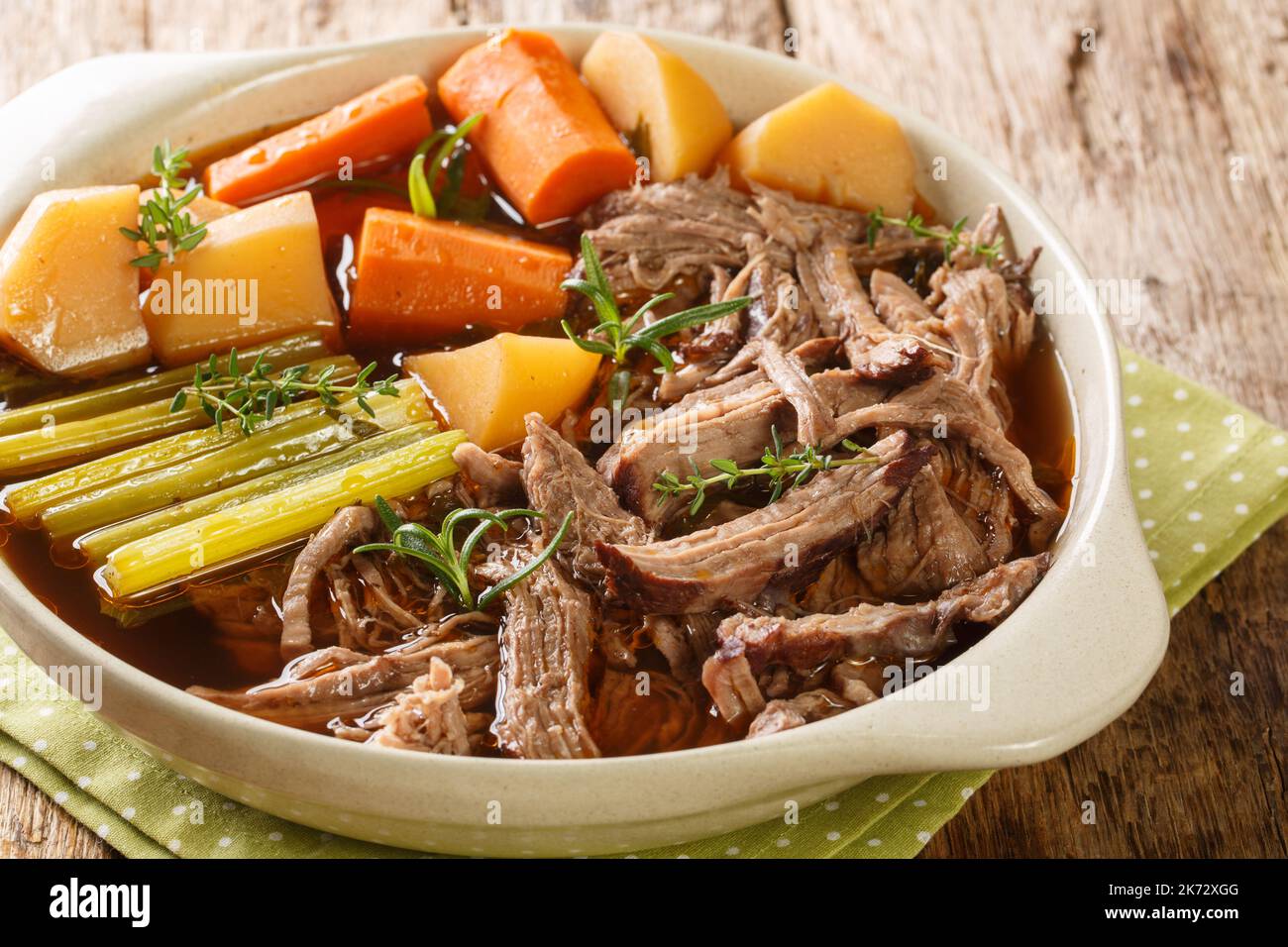 Roast pot of slow cooked beef with vegetables in a spicy sauce close-up ...