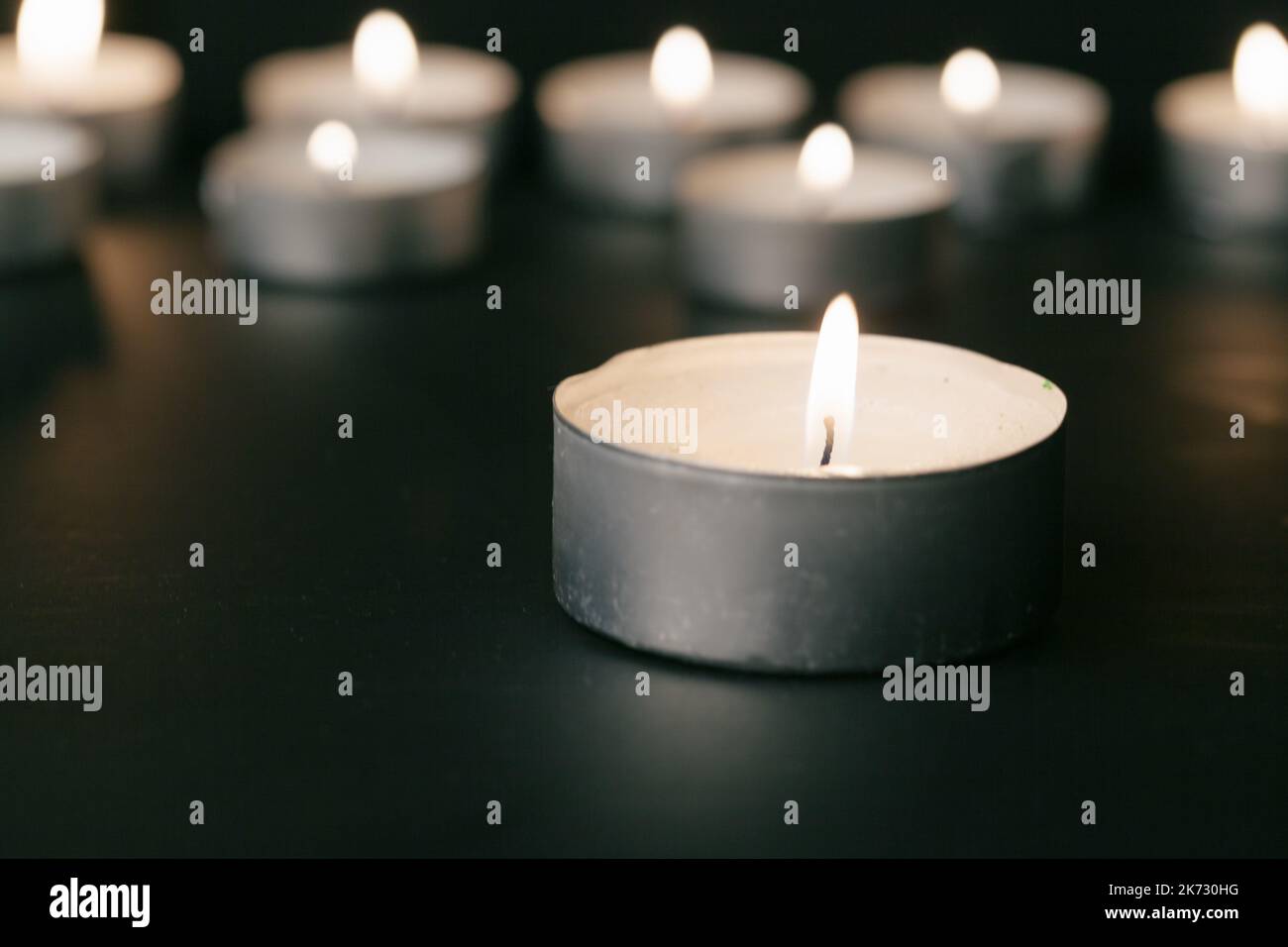Candles Burning at Night. White Candles Burning in the Dark Stock Photo