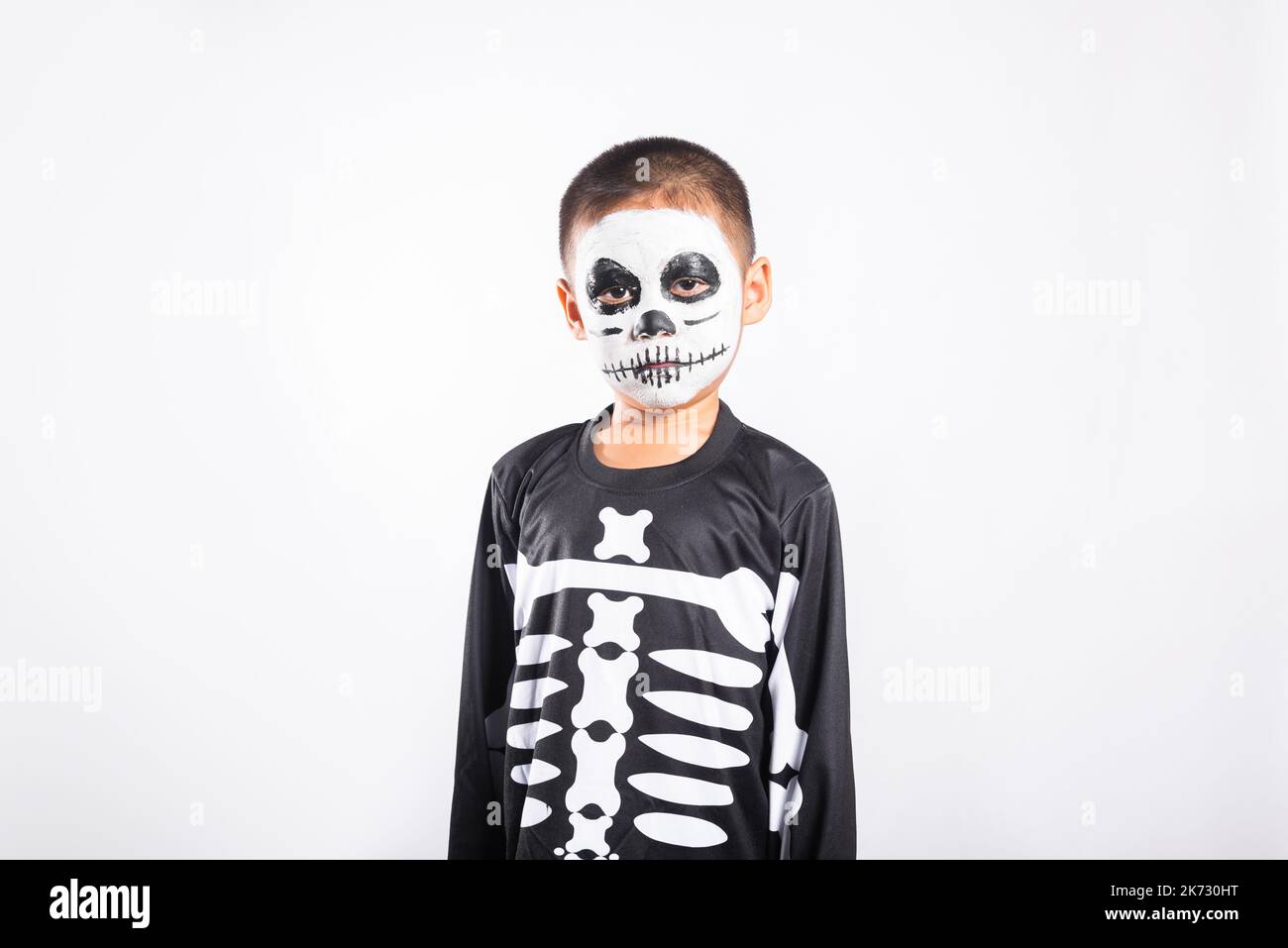 Children in carnival costumes with scary face painting on Halloween. Black  background. Stock Photo