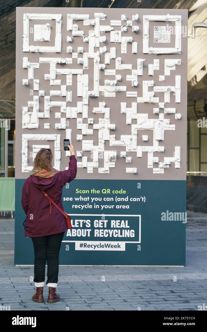 EDITORIAL USE ONLY A person uses a mobile phone to scan a QR code made with recycled materials outside Birmingham New Street station to mark beginning of Recycle Now's Recycle Week 2022. Picture date: Monday October 17, 2022. Stock Photo