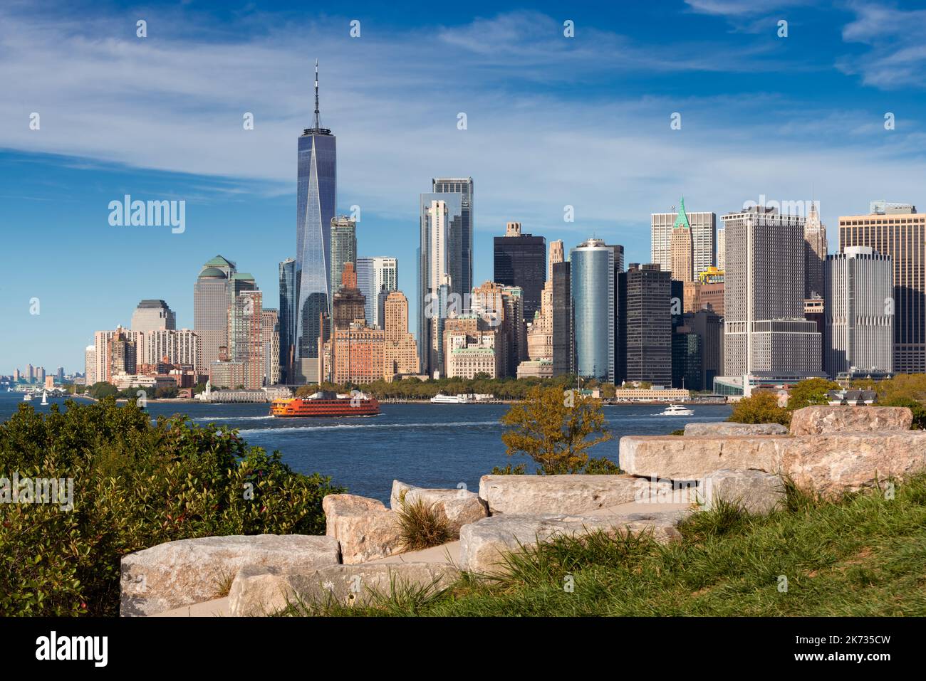 New York City skyline from Governor's Island. View of World Trade Center in Lower Manhattan (Financial District) and ferry boat Stock Photo