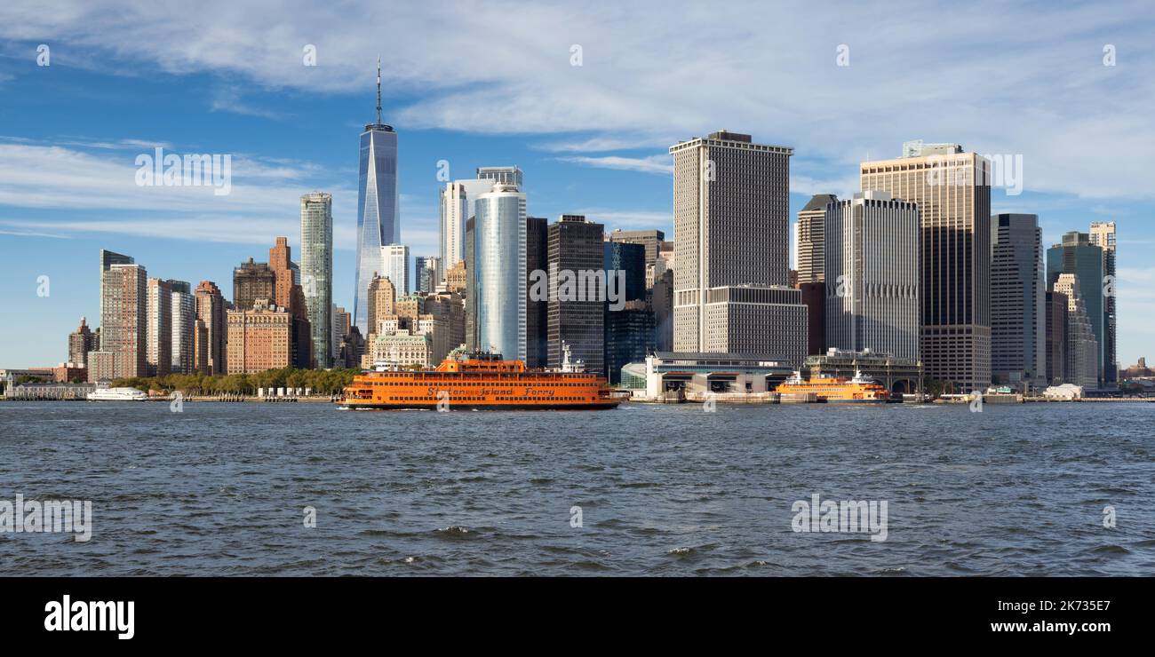 Skyline of New York City Lower Manhattan with Staten Island Ferry boat. View of World Trade Center in Financial District from New York Harbor Stock Photo