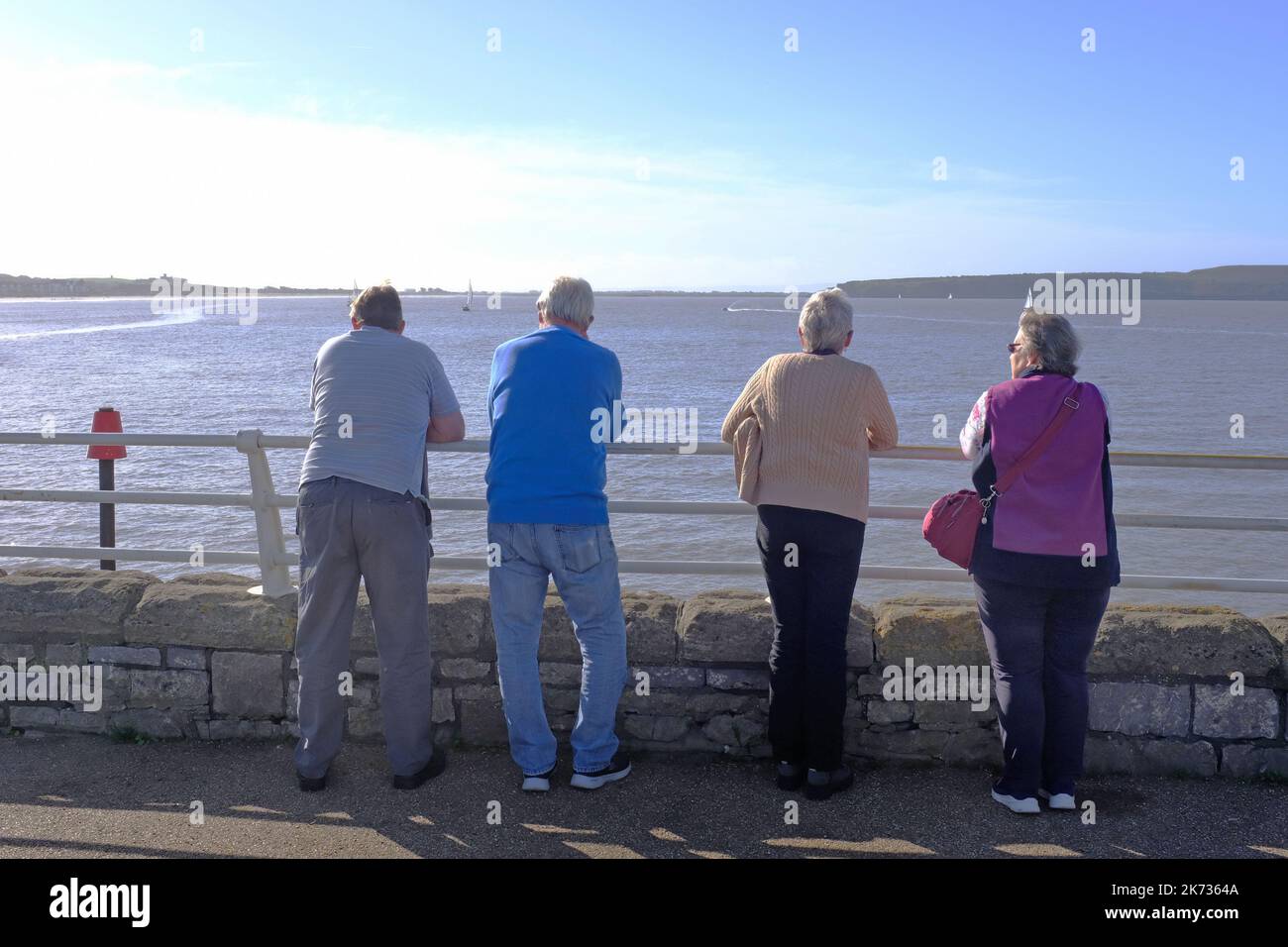 Four pensioners looking at the sea at Weston Super Mare. Stock Photo