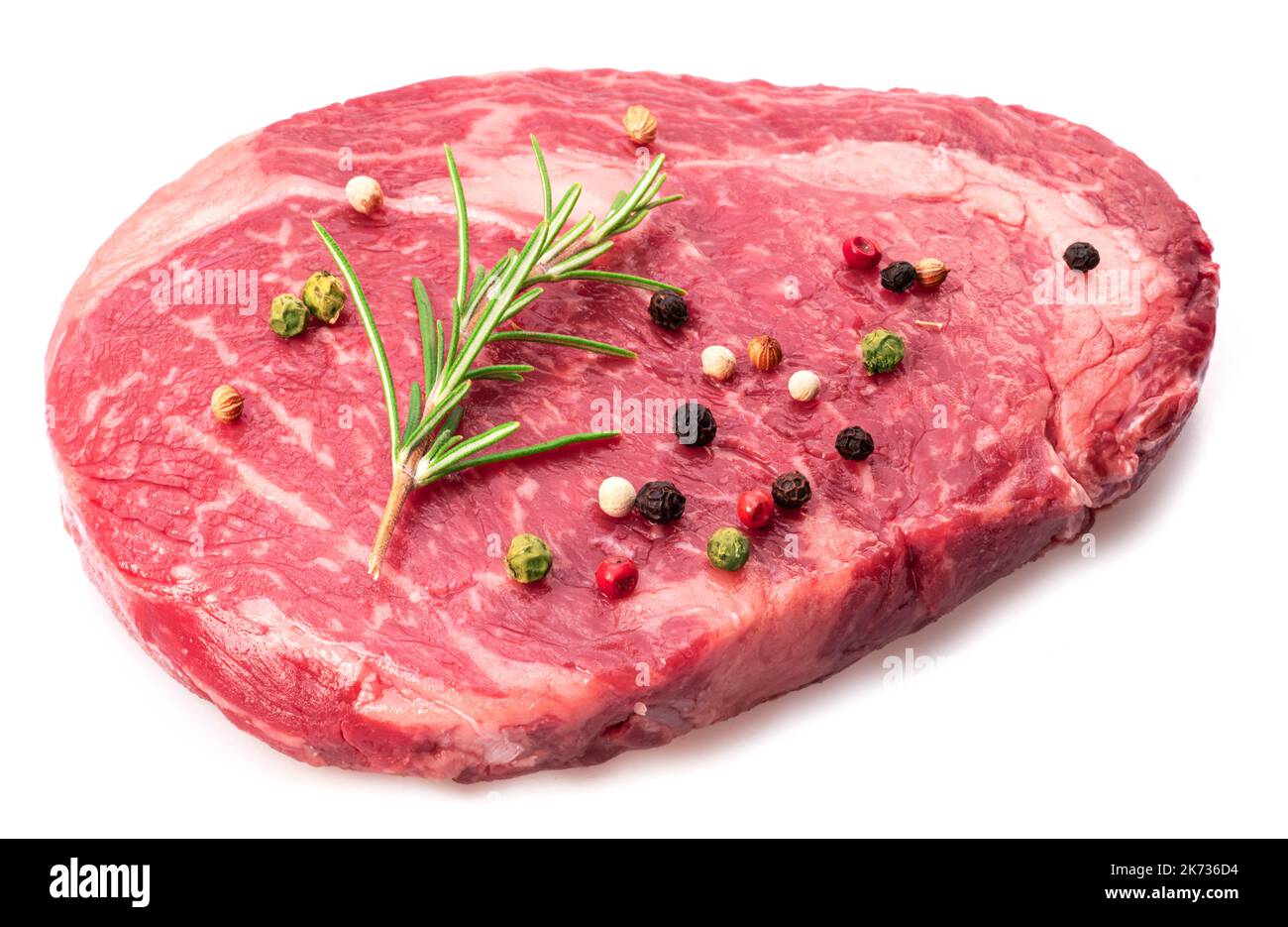 Ribeye steak with peppercorn and rosemary isolated on white background. Top view. Stock Photo