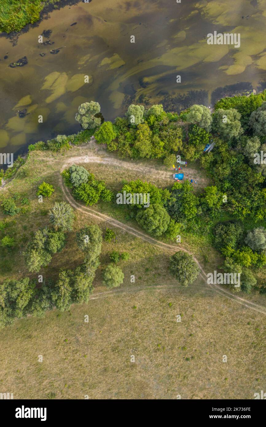 Kayaking and canoeing in the summer river. Aerial drone view on camping and river bank. Stock Photo