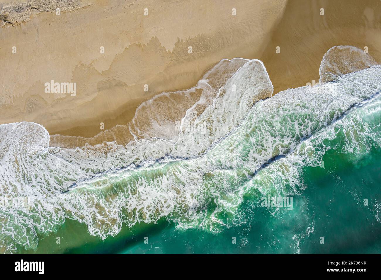 Aerial view looking down on waves crashing on beach, New Jersey, USA Stock Photo