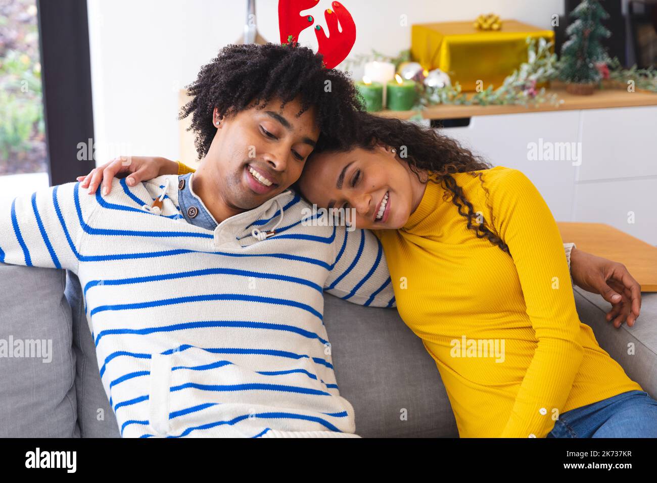 Happy african american couple sitting on sofa in living room and ...
