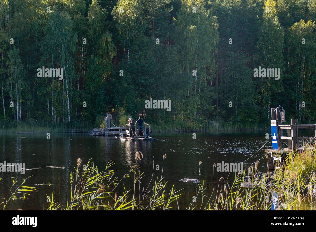 Kouvola, Finland. September 11, 2022. Ketunlossi (The Fox Ferry), hand pulled ferry with people on board in Repovesi National Park Stock Photo