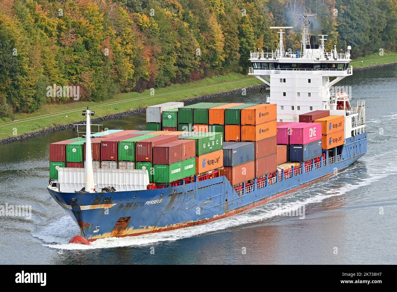 Small Containership PERSEUS passing the Kiel Canal Stock Photo