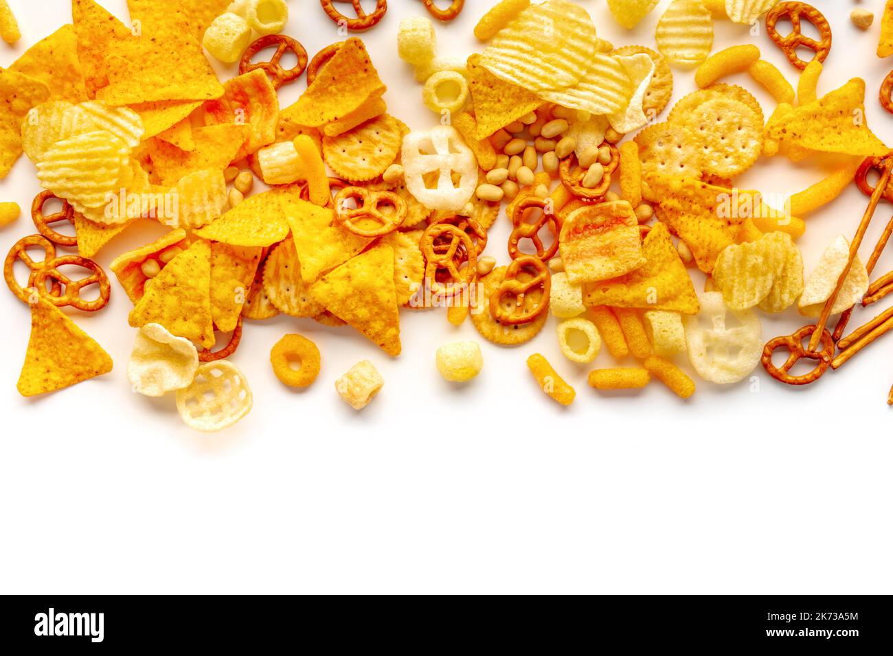 Salty snacks on white. Potato and tortilla chips, salt crackers etc ...