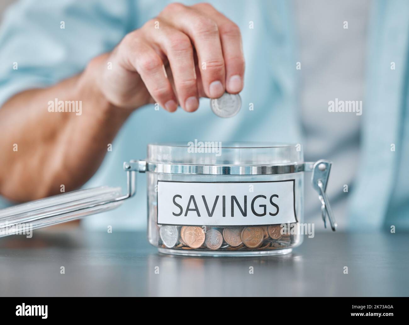 Set your saving goals early. an unrecognisable man sitting alone at ...