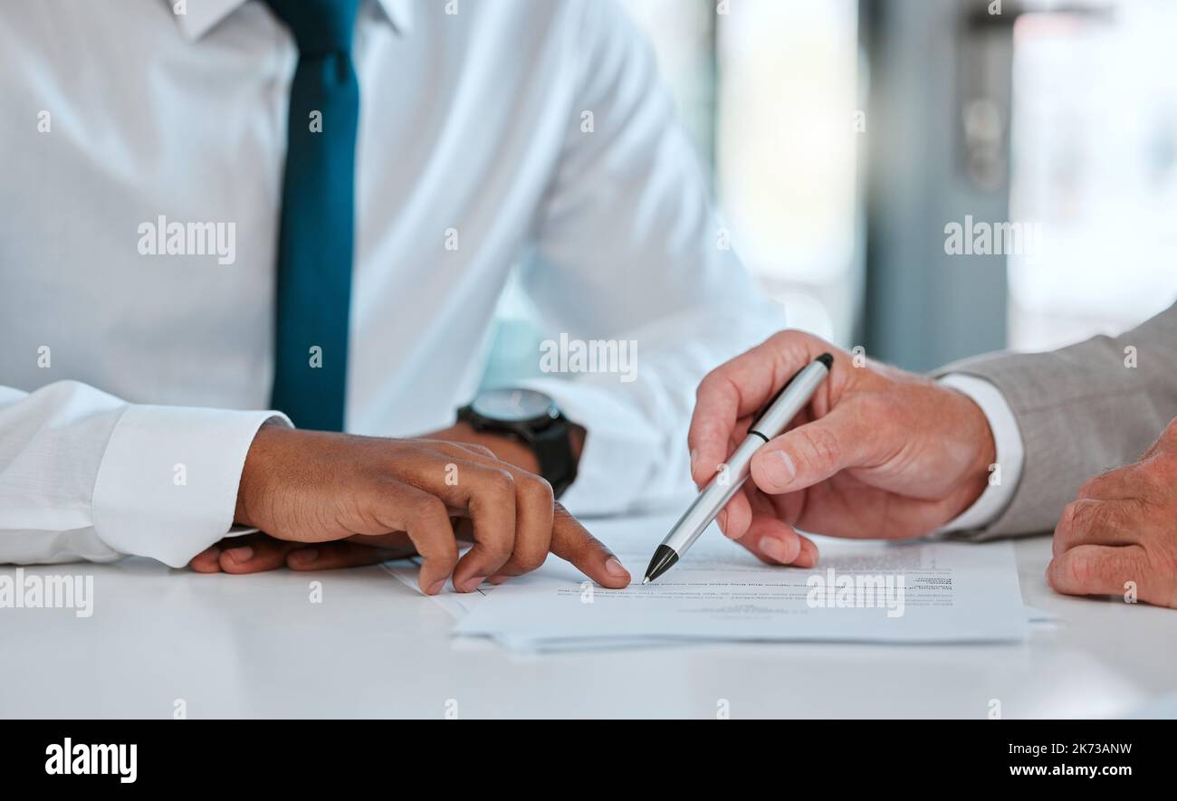 Sing on the dotted line. two unrecognizable males signing a contract in ...