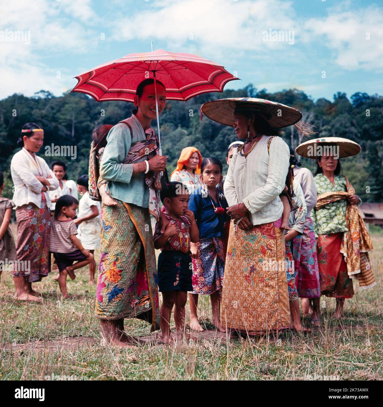 A vintage colour photograph taken in February 1965 showing members of the Dayak tribe of North Borneo Stock Photo