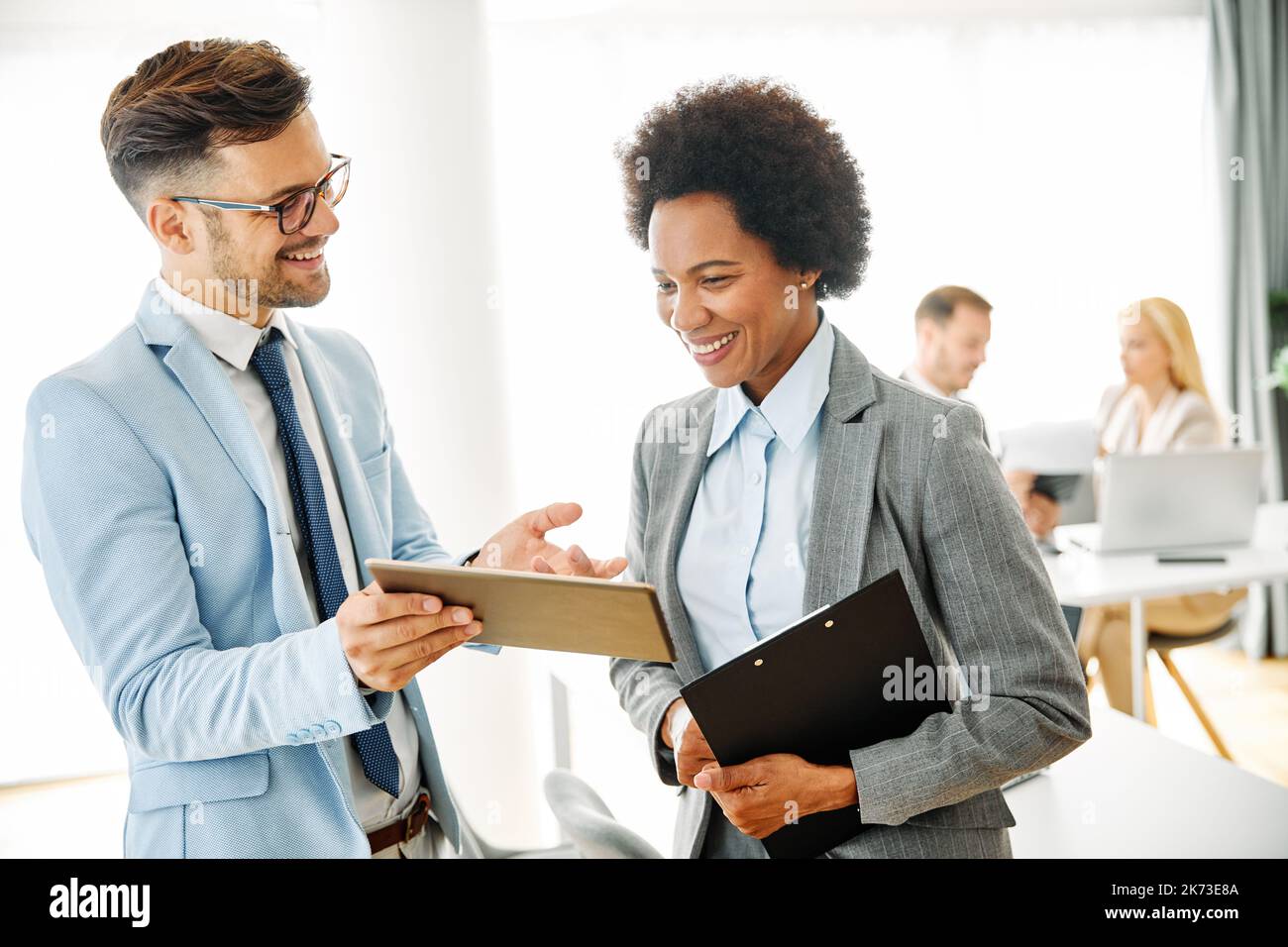 young business people meeting office teamwork group success corporate discussion tablet document Stock Photo