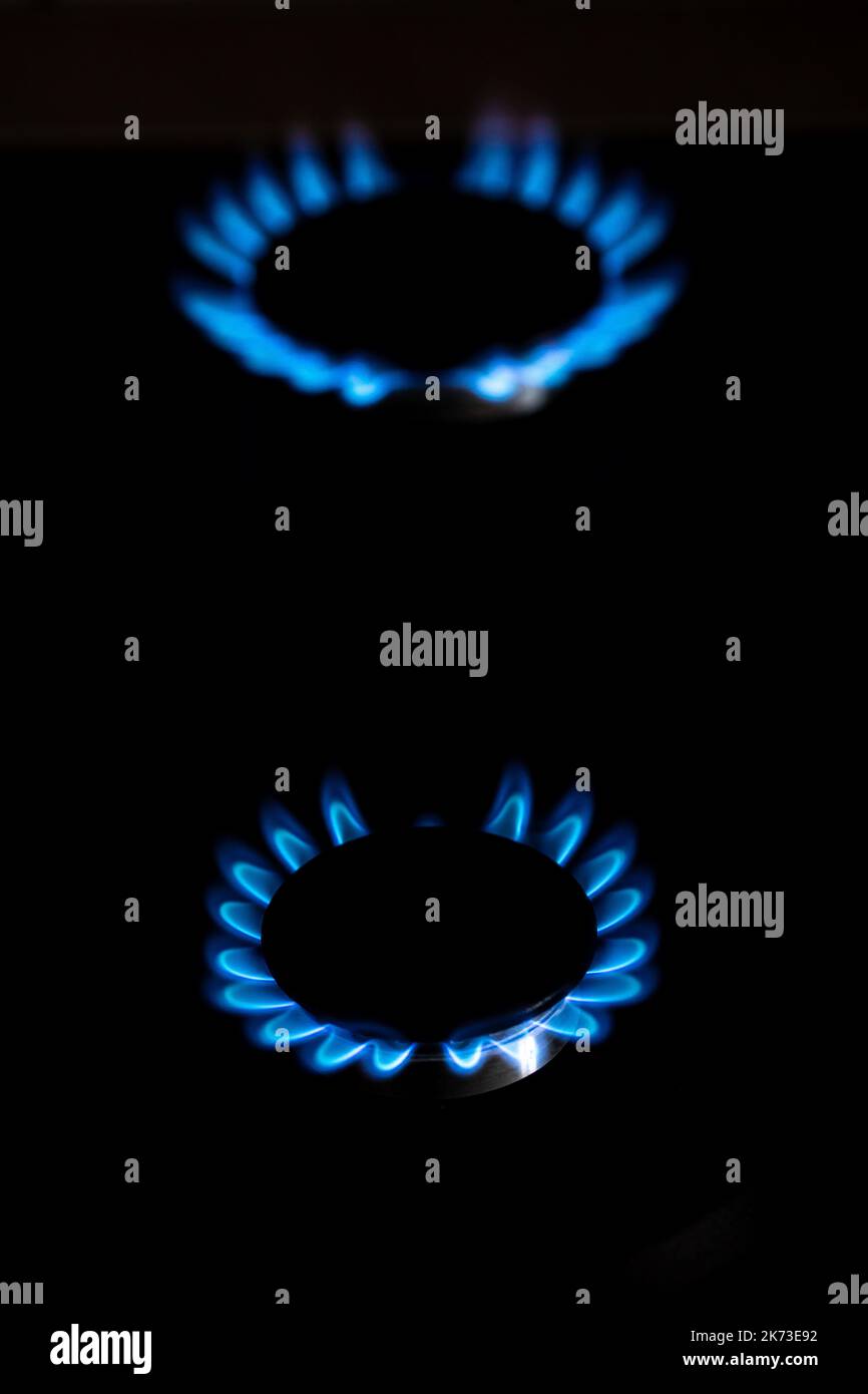 Closeup shot of blue fire from domestic kitchen stove top. Burning gas, gas stove burner. Gas cooker with burning flames of propane gas. Industrial re Stock Photo