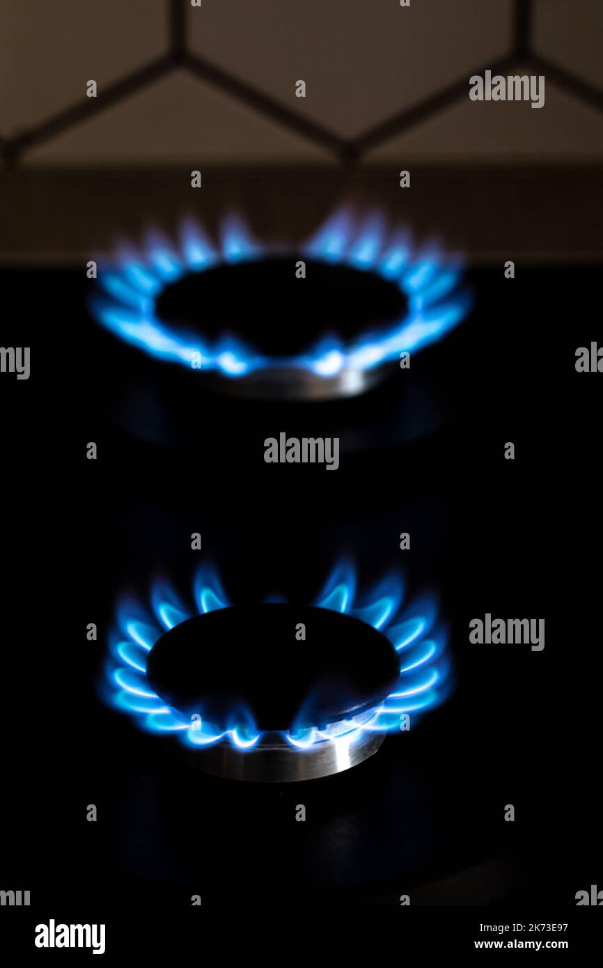 Closeup shot of blue fire from domestic kitchen stove top. Burning gas, gas stove burner. Gas cooker with burning flames of propane gas. Industrial re Stock Photo
