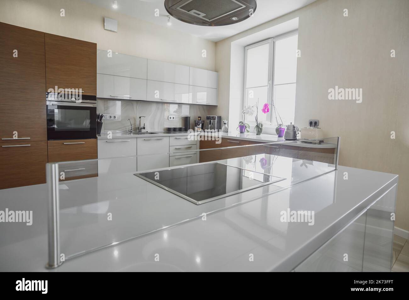 Modern electric stove surface in white light kitchen close up Stock
