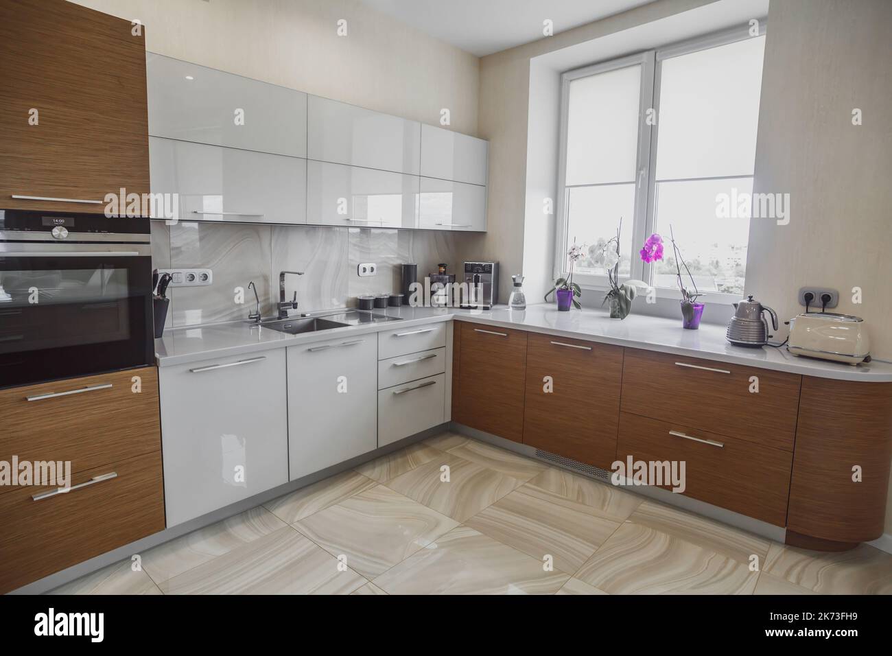 View of luxury expensive modern fitted kitchen with stainless steel