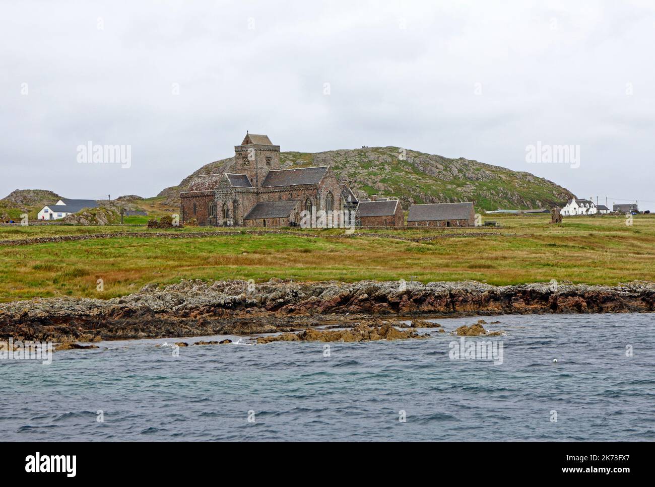 A view of the Abbey on the Isle of Iona taken from a passing boat in the Sound of Iona in the Inner Hebrides, Argyll and Bute, Scotland. Stock Photo