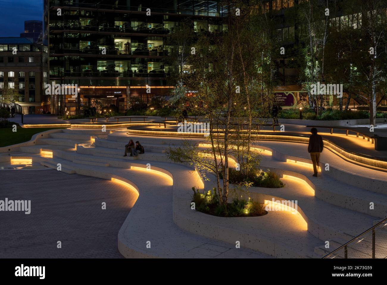 Evening wide view across square with city in background. Exchange Square, London, United Kingdom. Architect: DSDHA, 2022. Stock Photo