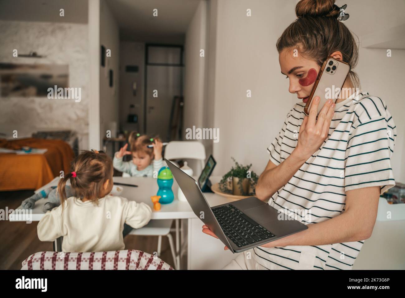 Busy remote worker and her children in the kitchen Stock Photo Alamy
