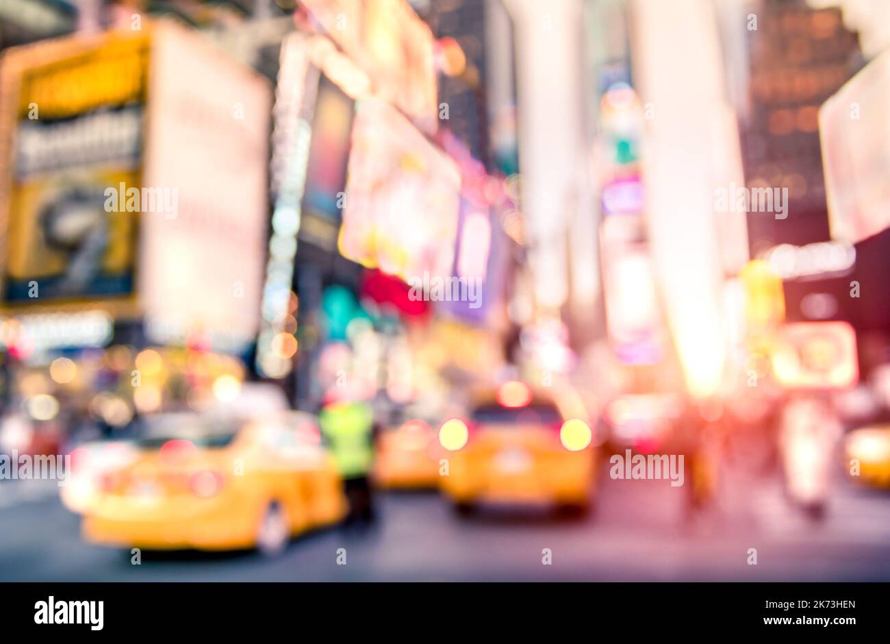 Traffic jam with defocused yellow taxi cabs and rush hour on Times Square in Manhattan downtown at sunset - Blurred bokeh postcard of New York City on Stock Photo