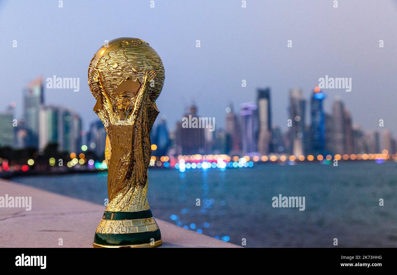 FIFA World Cup trophy in front of Doha, Qatar skyline Stock Photo