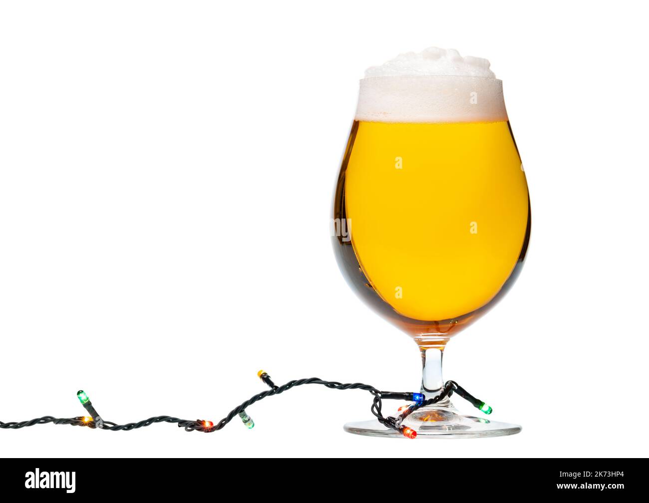 Full snifter glass of lager of pilsner beer with christmas lights