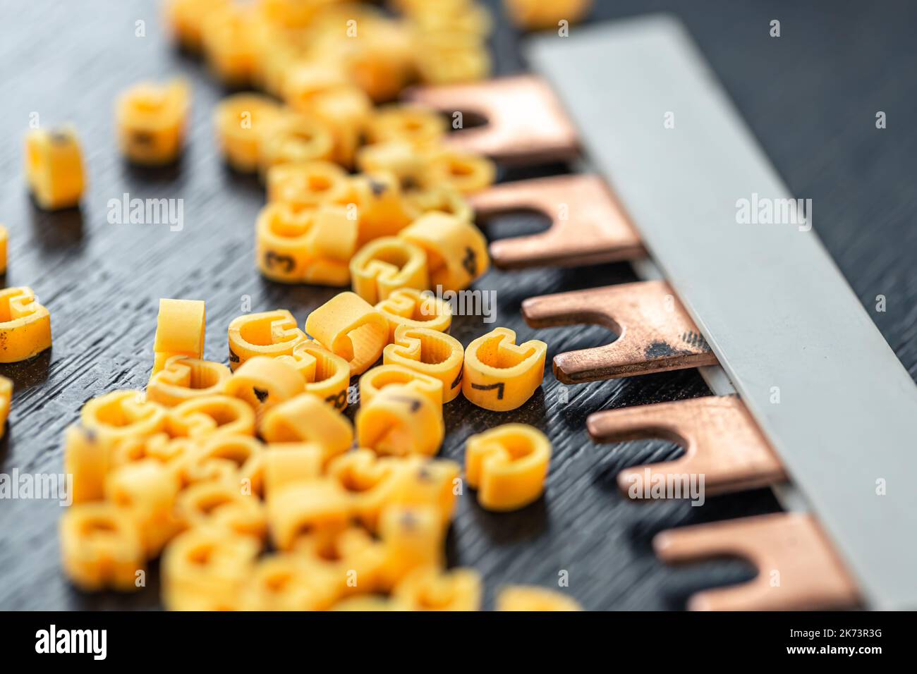 Cable markers scattered on the table, macro shot. Stock Photo