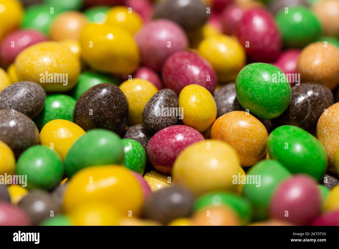 Peanuts covered with multicolored glaze, close up. Stock Photo
