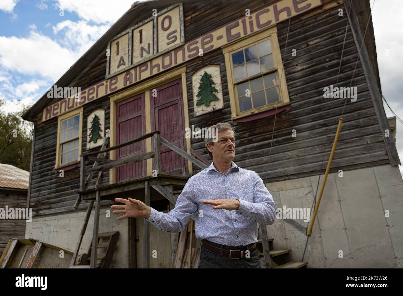 Francois Cliche gestures as he speaks in front of his business affected by the last flood of the Chaudiere River, the Scierie-menuiserie Alphonse Clic Stock Photo