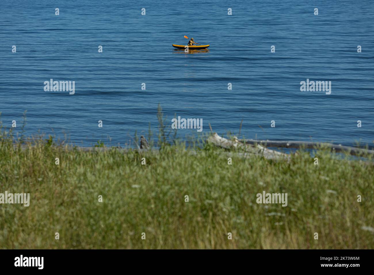 A man rows his small boat near the beach in Carleton-sur-Mer on July 28, 2022. Stock Photo