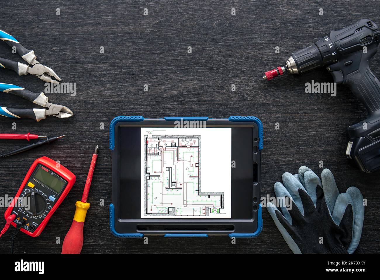 Composition with digital tablet and electrician work items. Stock Photo