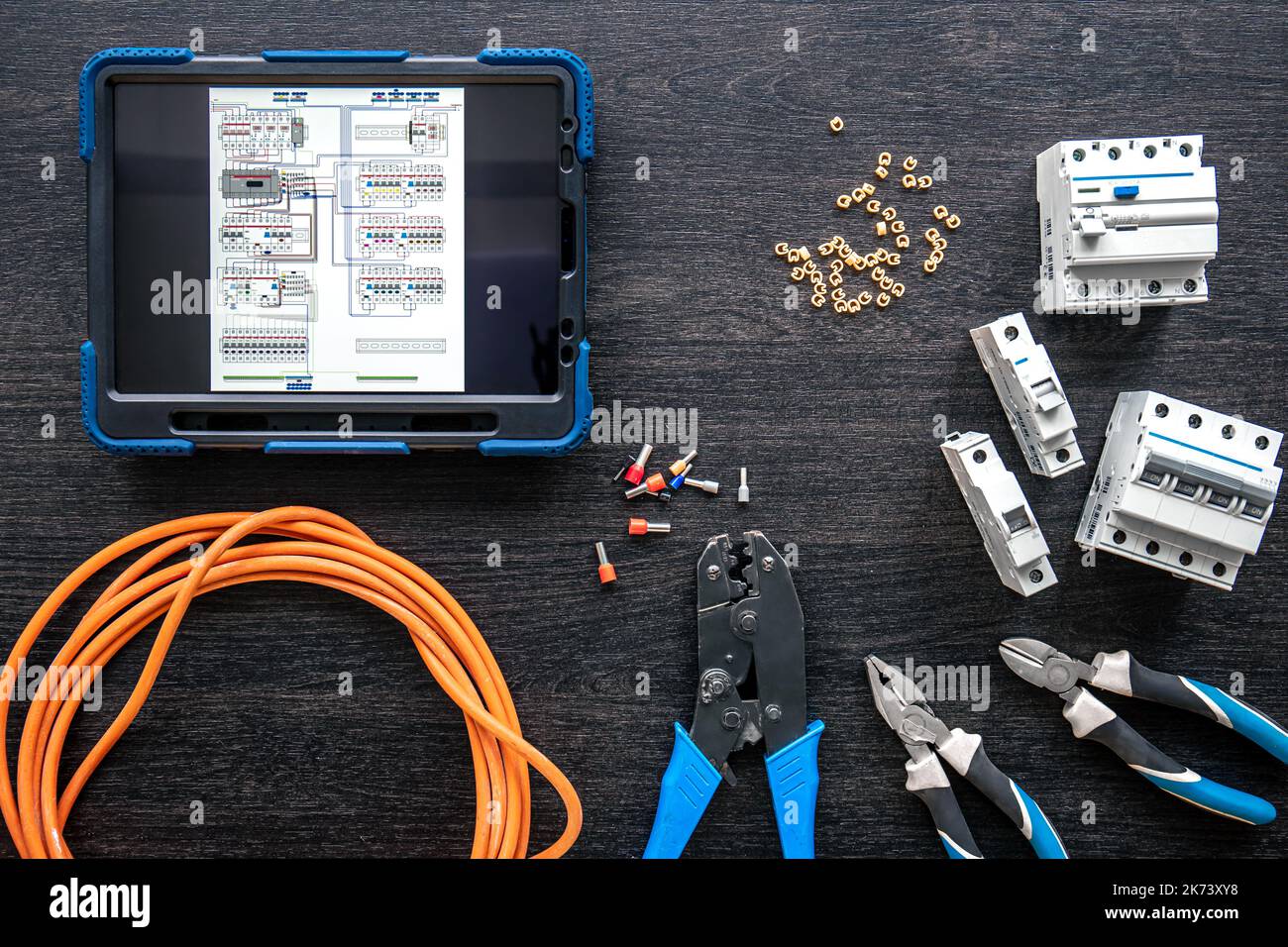 Different electrical tools and digital tablet on wooden background, flat lay. Stock Photo