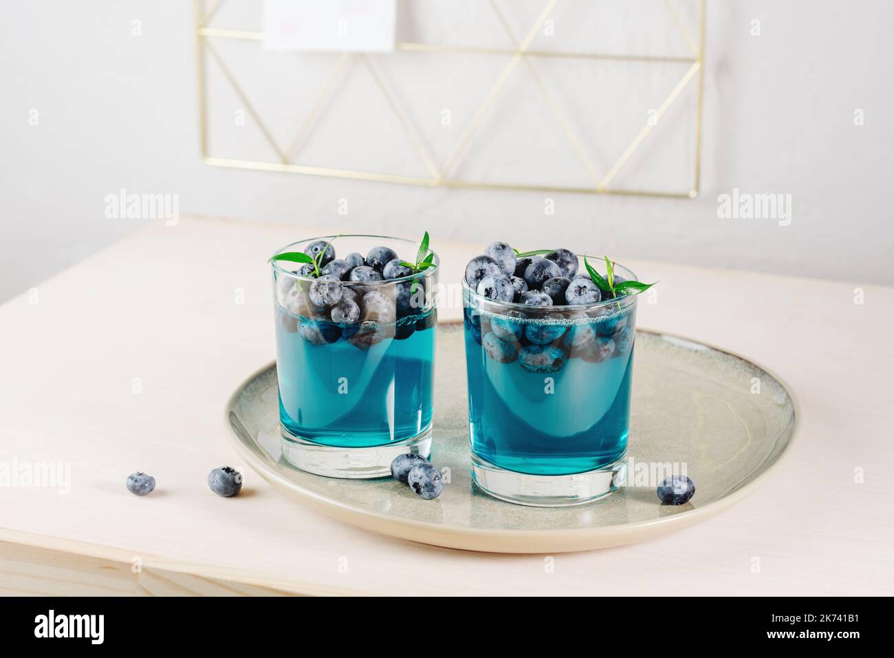 Two glasses of blueberry gelatin dessert on a tray. Stock Photo