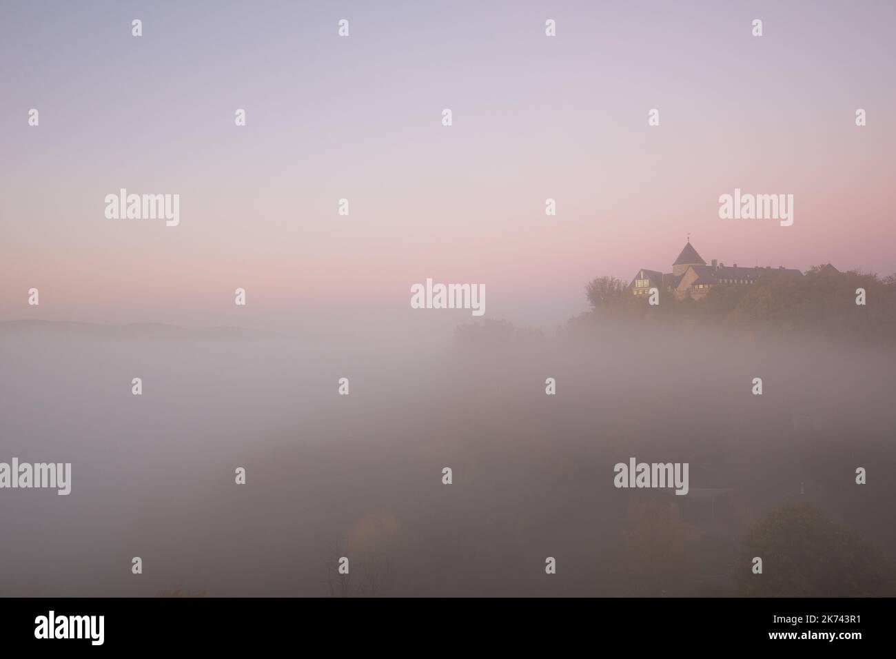 View to german palais called Waldeck in the morning with fog over the lake Edersee Stock Photo