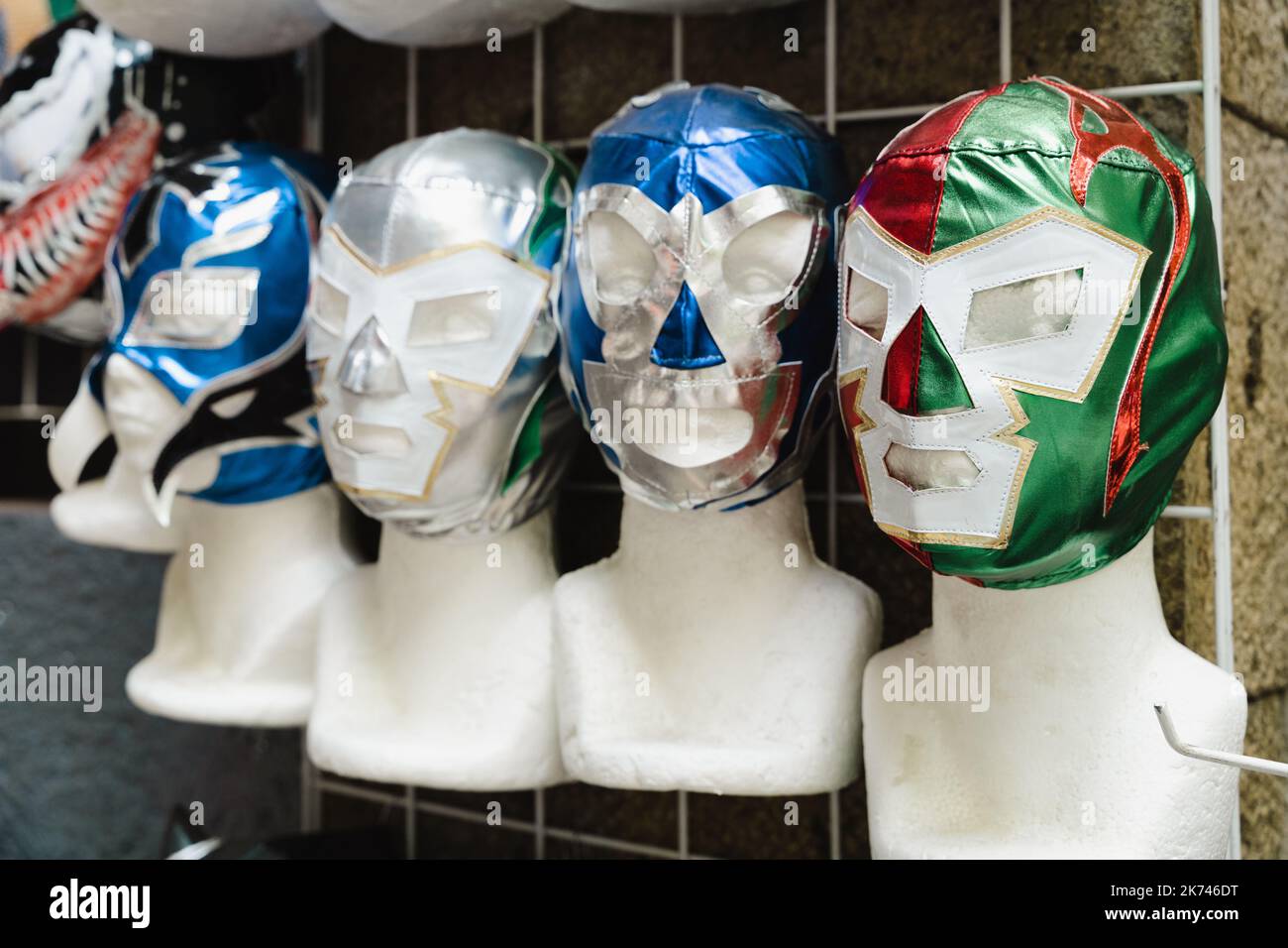 Mexican wrestling masks on mannequin heads. Traditional sport souvenir from Mexico Stock Photo