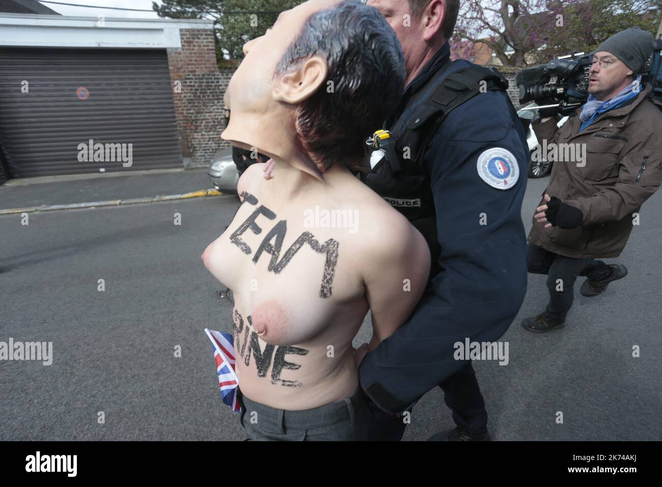 Members of feminist activist group Femen protest against French presidential election candidate for the far-right Front National  party Marine Le Pen outside a polling station in Henin-Beaumont, during the first round of the Presidential election.  Stock Photo