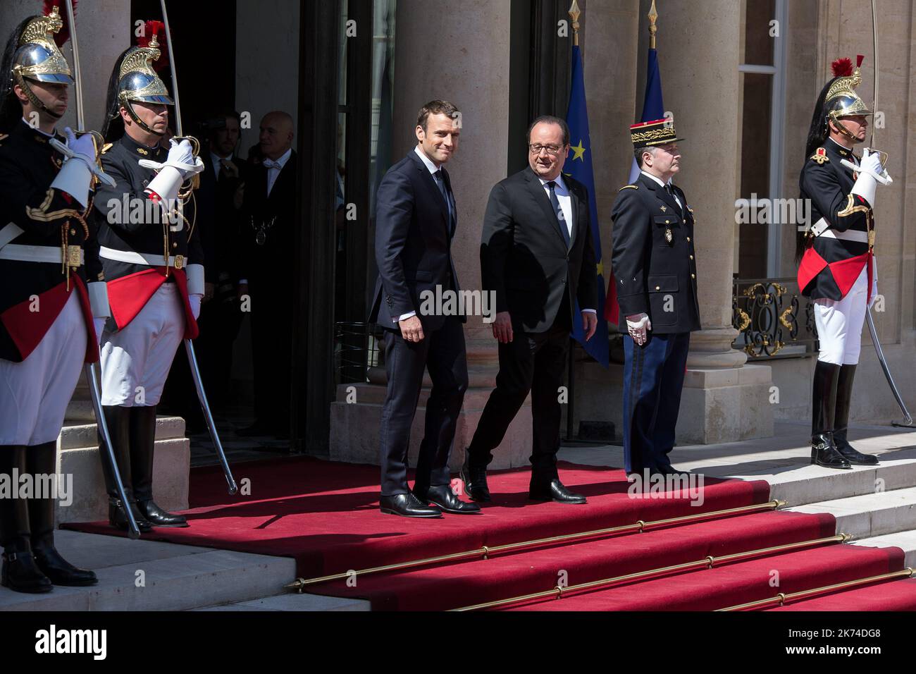 French outgoing President Francois Hollande walks with his successor ...