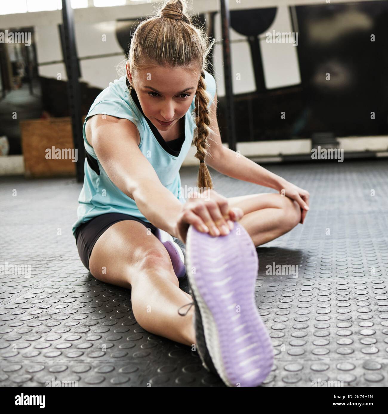 Stretch for your own benefit a young woman sitting on the floor and