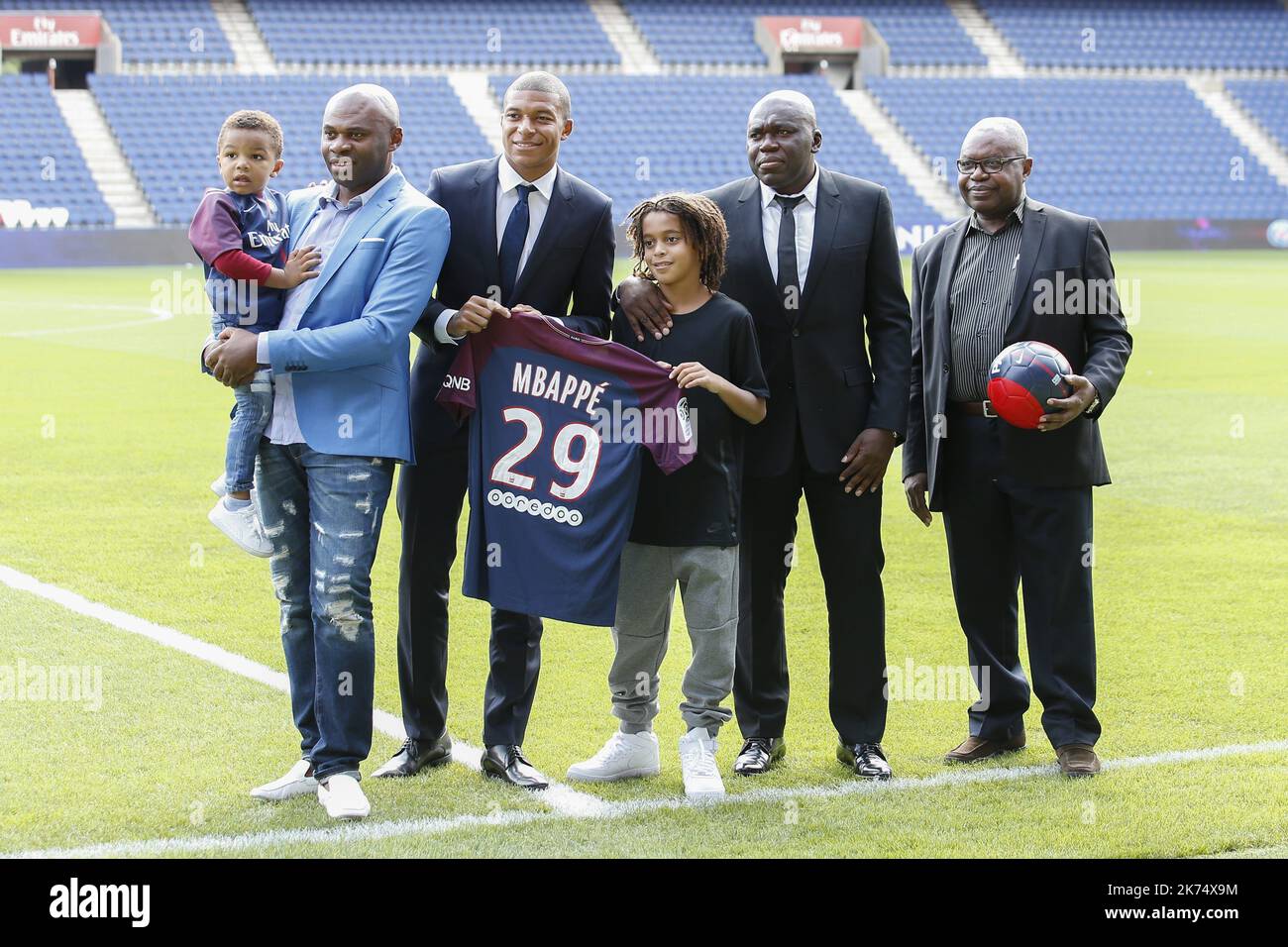Paris Saint-Germain's new forward Kylian Mbappe together with father Wilfried Mbappe and his brother Ethan and other members of his family pose for a photo during the presentation of his jersey at the Parc des Princes stadium in Paris Stock Photo