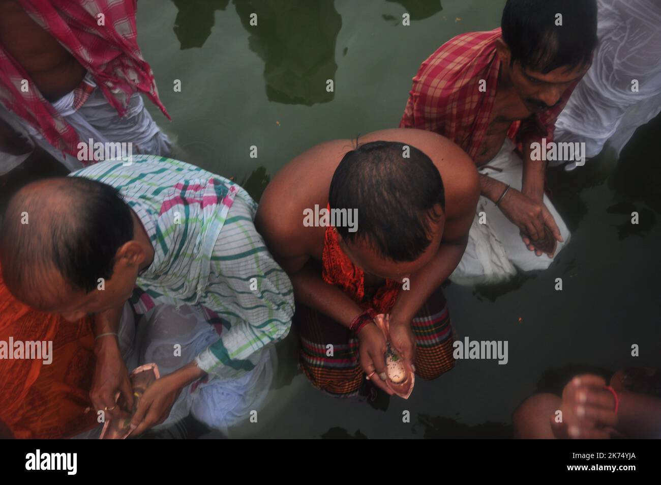Indian Hindu devotees perform Tarpan, also known as Pitritarpan in Tripura. Tarpan is a ritual to pay obeisance to one's forfathers, and on its last day on September 19, 2017, they prayed their ancestors. In Hindu mythology, this day is also called -Mahalaya- and described as the day when the Gods created the ten armed Godess Durga to destroy the demon king Asur who plotted to drive out the gods from their kingdom. During this five-day period, they worship of Durga, who is recognized as the destroyer of evil. Stock Photo