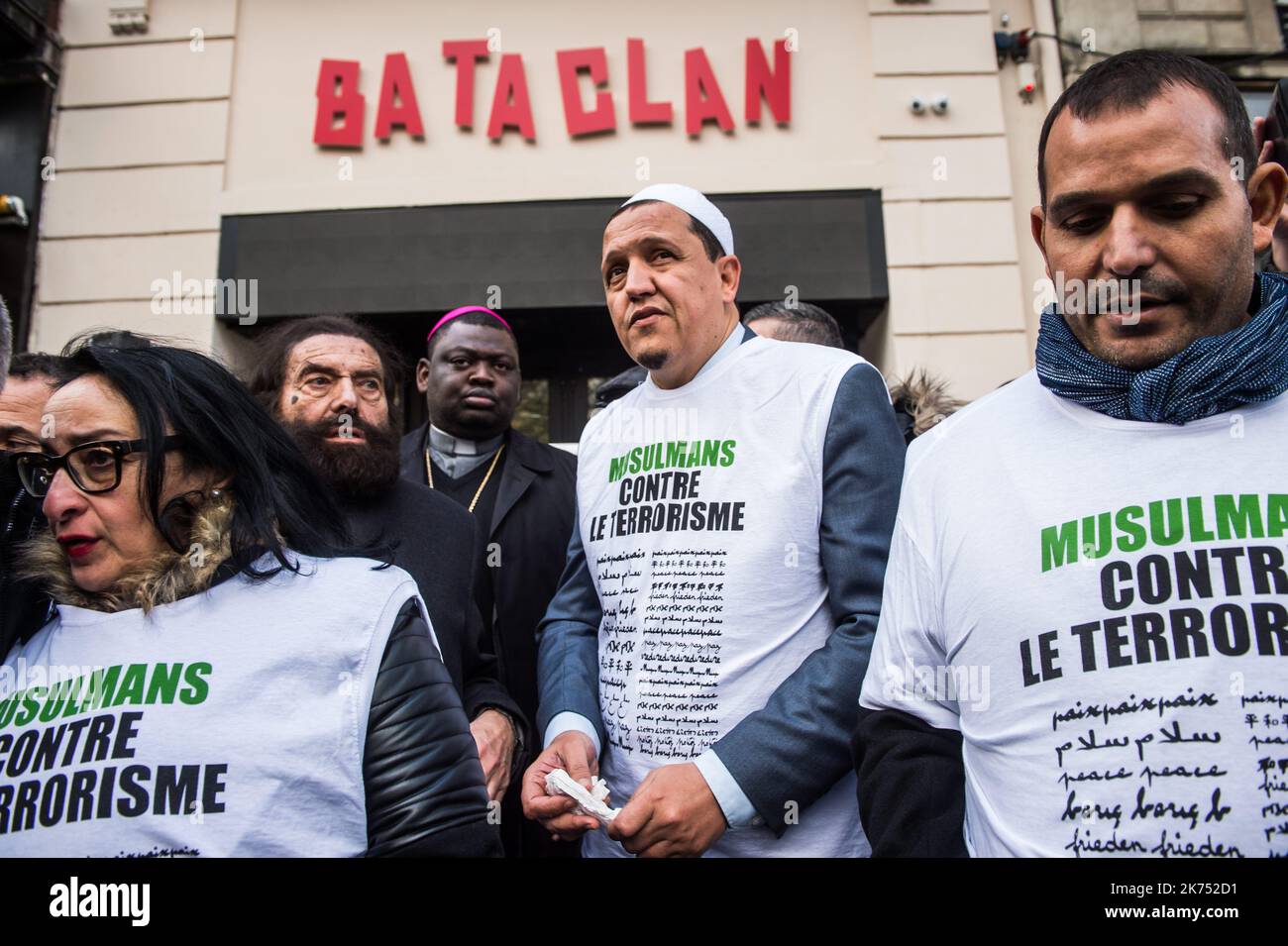Imam Hassen Chalghoumi (R) and French author Marek Halter (L) gather with a group dubbed 'Muslims against Terrorism'  in front of the  Bataclan concert venue during a ceremony marking the second anniversary of the Paris attacks of November 2015 in which 130 people were killed.  Stock Photo
