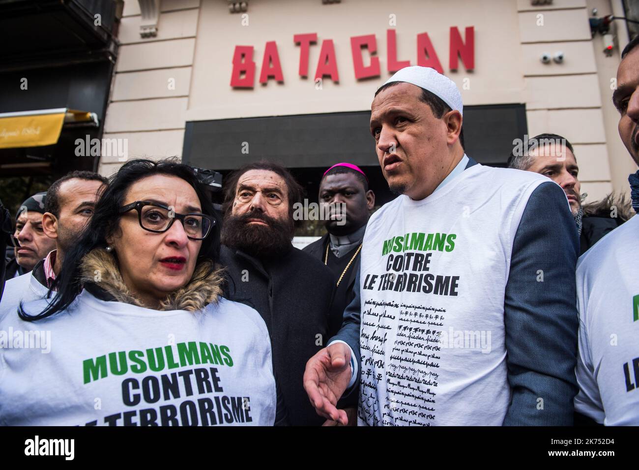 Imam Hassen Chalghoumi (R) and French author Marek Halter (L) gather with a group dubbed 'Muslims against Terrorism'  in front of the  Bataclan concert venue during a ceremony marking the second anniversary of the Paris attacks of November 2015 in which 130 people were killed.  Stock Photo